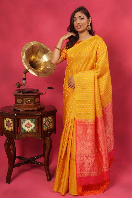 Yellow pure silk in gold buttas with contrast pallu.