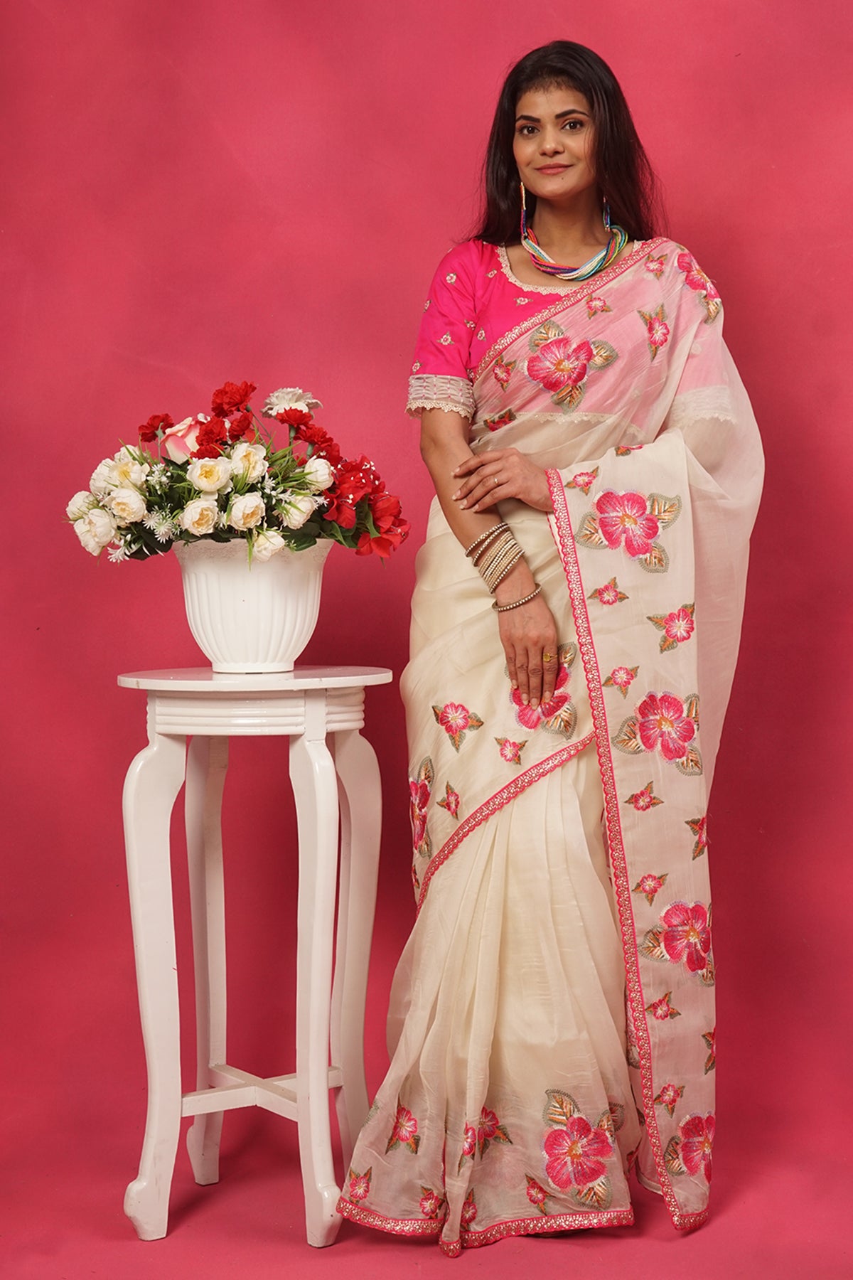 Off white organza floral embroidered saree with pink designer blouse