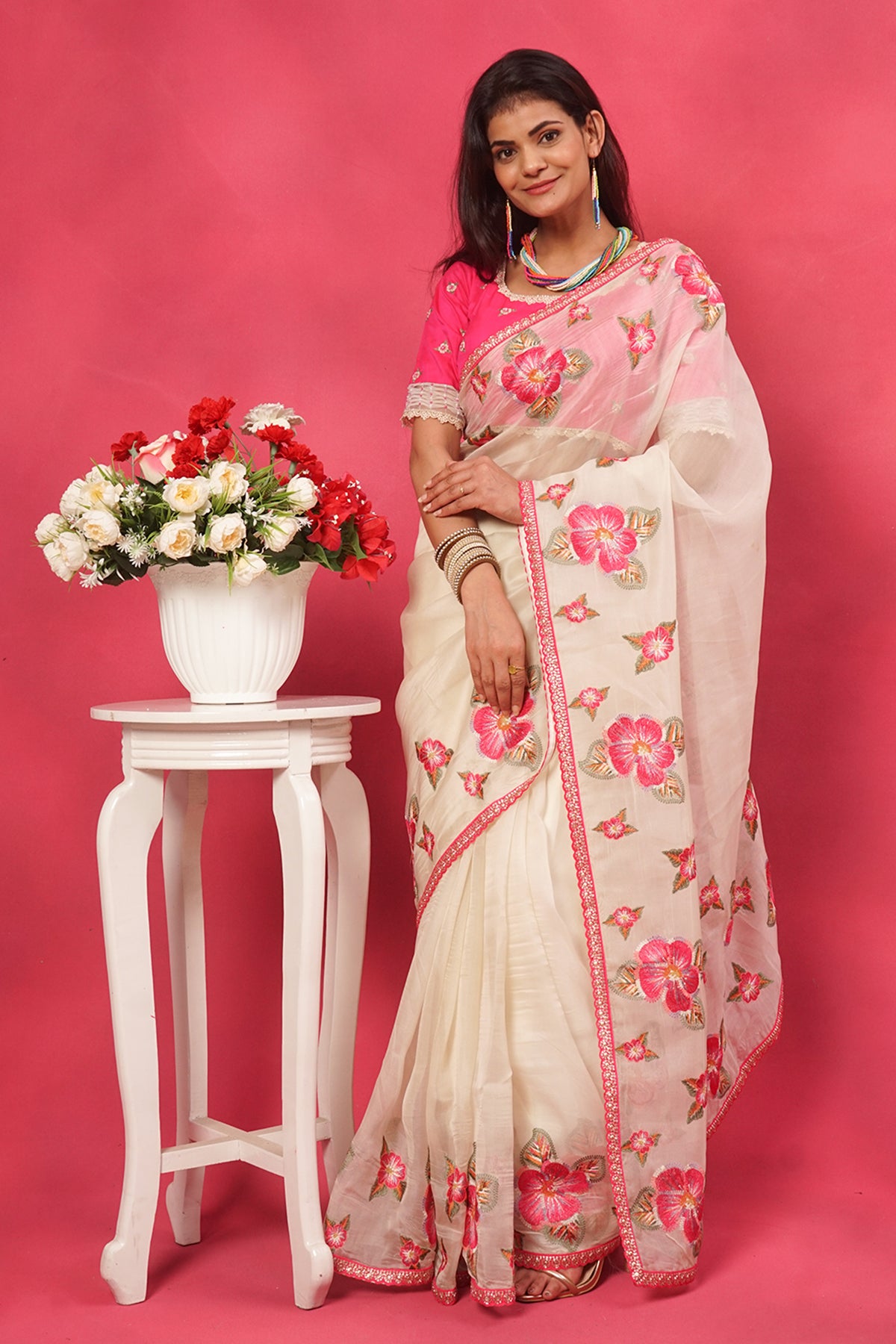 Off white organza floral embroidered saree with pink designer blouse